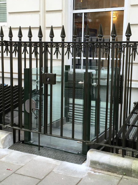Black gate for entrance to lightwell lift