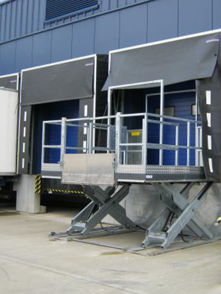 A blue door next to a scissor platform lift
